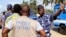 FILE—A policeman gestures at a journalist during a sit-in near the presidency, to protest against a new media law in Lome March 14, 2013.