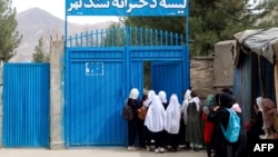 Afghan primary school girls arrive for their first class following the start of the new academic year, at a school in Fayzabad district, Badakhshan province on March 20, 2024.