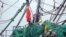 FILE: A Chinese flag flies on a Chinese fishing trawler docked at the port of Abidjan after being stopped by an Ivory Coast navy patrol and being accused of fishing illegally off the coast of the West African country on Nov. 28, 2014.