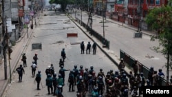 Members of Border Guard Bangladesh (BGB) and the police work to control the protesters outside the state-owned Bangladesh Television as violence erupts after anti-quota protests by students, in Dhaka, Bangladesh, July 19, 2024.