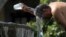 A man cools himself down with water from a water fountain during one of the hottest days of the third heat wave in Guadalajara, Jalisco state, Mexico, on June 12, 2023. 