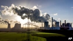 File - Steam rises from the coal-fired power plant Neurath near Grevenbroich, Germany, Nov. 2, 2022