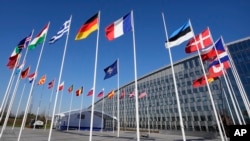 FILE - Flags of member nations at NATO headquarters.
