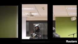 Police inspect a building after a shooting in the northern German city of Hamburg, March 9, 2023.