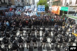 An aerial view shows security forces standing guard as protesters rally against cuts by the government of President Javier Milei in the most vulnerable sectors, on March 18, 2024, in Avellaneda, Buenos Aires province, Argentina.