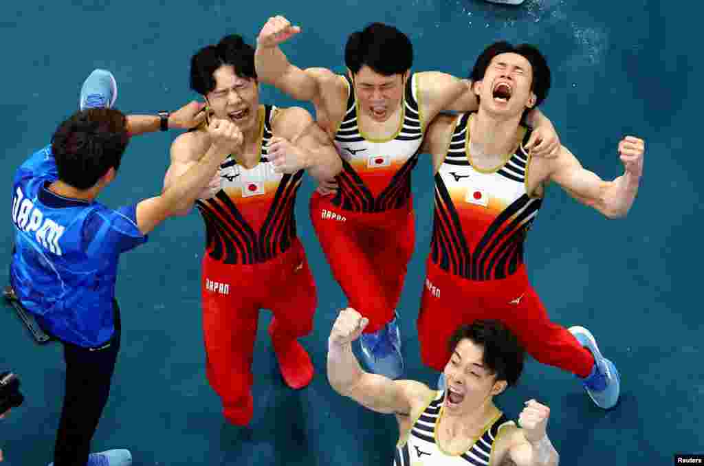 Japan&#39;s Kazuma Kaya, Shinnosuke Oka, Takaaki Sugino and Wataru Tanigawa celebrate their winning the artistic gymnastics men&#39;s team final during the Paris 2024 Olympic Games at the Bercy Arena in Paris, July 29, 2024.