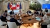Summit host, Italian Prime Minister Georgia Meloni, top center, addresses fellow G7 leaders during a roundtable session on the first day of their summit, at Borgo Egnazia, southern Italy, June 13, 2024.