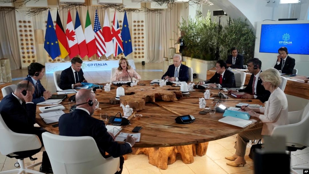 Summit host, Italian Prime Minister Georgia Meloni, top center, addresses fellow G7 leaders during a roundtable session on the first day of their summit, at Borgo Egnazia, southern Italy, June 13, 2024.