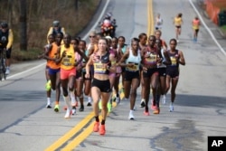 Emma Bates takes the lead after the start of the Boston Marathon, in Hopkinton, Massachusetts, April 15, 2024. Bates was the top American finisher.