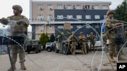 (FILE) U.S. soldiers, part of the peacekeeping mission in Kosovo, guard a municipal building in the town of Leposavic, Kosovo.