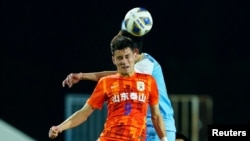 FILE - Shandong Taisha's Behram Abduweli, in red, is pictured in AFC Champions League play against Daegu FC in Buriram, Thailand, April 15, 2022. 