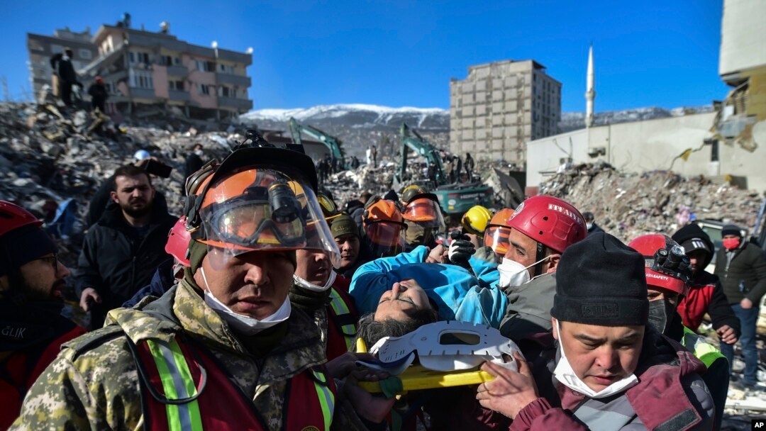 Turkish rescue workers from Kazakhstan and Turkey pull out Hatice Akar from a collapsed building 180 hours after the earthquake in Kahramanmaras, southern Turkey, early Monday, Feb. 13, 2023.