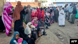 FILE—People from states of Khartoum and al-Jazira, displaced by the ongoing conflict in Sudan between the army and paramilitaries, wait to receive aid from a charity organisation in Gedaref on December 30, 2023.