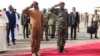 Niger's General Abdourahamane Tiani, right, salutes next to his Burkinabe counterpart Captain Ibrahim Traore left, upon his arrival in Niamey, July 5, 2024.
