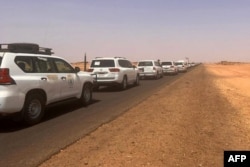 FILE - A convoy leaving Khartoum advances on a road towards Port Sudan, on Apr. 23, 2023, as people flee the battle-torn Sudanese capital. (Photo by Abubakarr JALLOH / AFP)