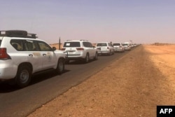 FILE - A convoy leaving Khartoum advances on a road towards Port Sudan, on Apr. 23, 2023, as people flee the battle-torn Sudanese capital.