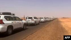 FILE - A convoy leaving Khartoum advances on a road towards Port Sudan, on Apr. 23, 2023, as people flee the battle-torn Sudanese capital.