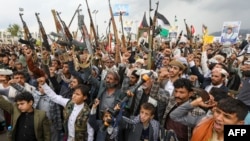 Armed Yemenis chant slogans during a demonstration denouncing the killing of Hamas chief Ismail Haniyeh and Hezbollah senior commander Fouad Shukur in the Houthi-controlled capital Sanaa on Aug. 2, 2024.