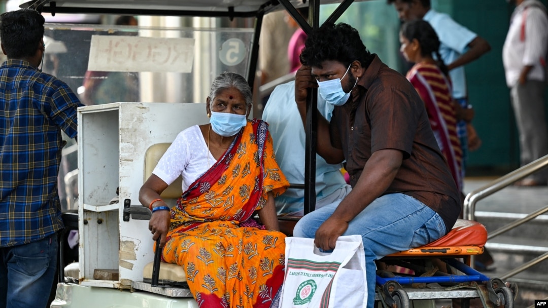 People wear face masks as they arrive at a government hospital in Chennai, India, on April 1, 2023, amid a rise in COVID-19 cases in India. 