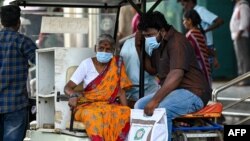 People wear face masks as they arrive at a government hospital in Chennai, India, on April 1, 2023, amid a rise in COVID-19 cases in India. 