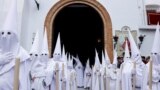 Penitents belonging to La Paz (The Peace) brotherhood take part in a Palm Sunday procession in Seville, Spain, March 24, 2024. 