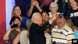 After speaking at a campaign rally at Sherman Middle School in Madison, Wisconsin, U.S. President Joe Biden takes a photo with supporters, July 5, 2024.