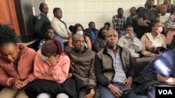 Election monitors sit in a packed courtroom in Harare, Aug. 25, 2023. They were freed after being charged with plotting to release unofficial results of the general elections. (Columbus Mavhunga/VOA)