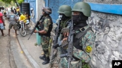 FILE - Police stand guard outside the office of the prime minister in preparation for the swearing-in of a transitional council, in Port-au-Prince, Haiti, April 25, 2024. The council appointed a new Cabinet on June 11, 2024.