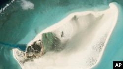 FILE - This satellite photo from Planet Labs PBC shows Triton Island in the South China Sea on Feb. 20, 2023. 