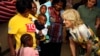 U.S. first lady Jill Biden, right, smiles at children during a visit to a U.S. President's Emergency Plan for AIDS Relief project at an informal settlement near Windhoek, Namibia, Feb. 23, 2023.