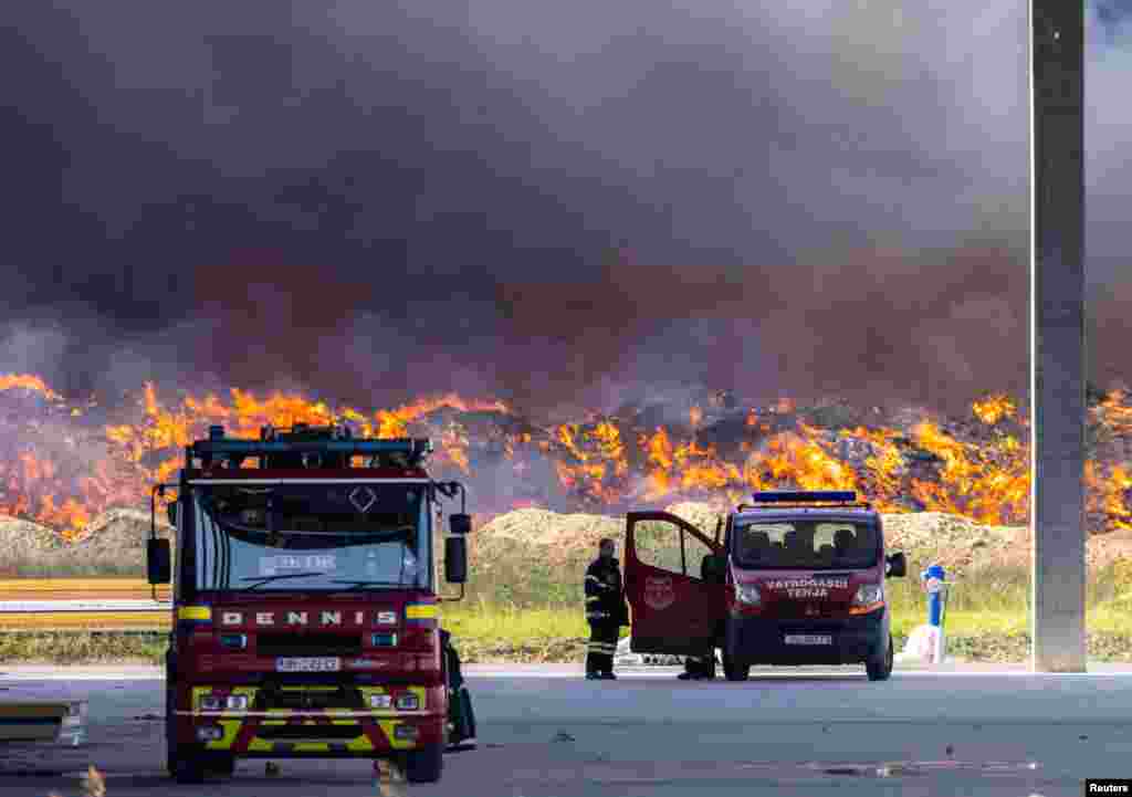 A firefighter stands near the fire at Drava International factory near Osijek, Croatia.&nbsp;A large fire at a plastics depot has spread to a nearby building where chemicals were stored, releasing toxic fumes that could pose ecological risks as strong winds began to carry them south,&nbsp;officials said.