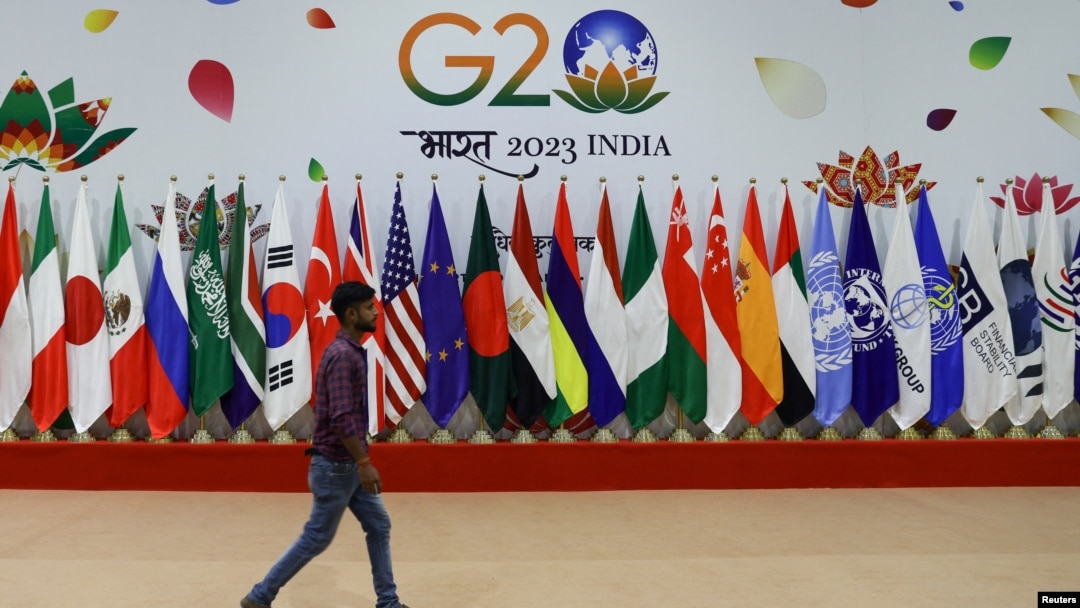 A man walks near flags ahead of G20 Summit in New Delhi, Sept. 8, 2023. 