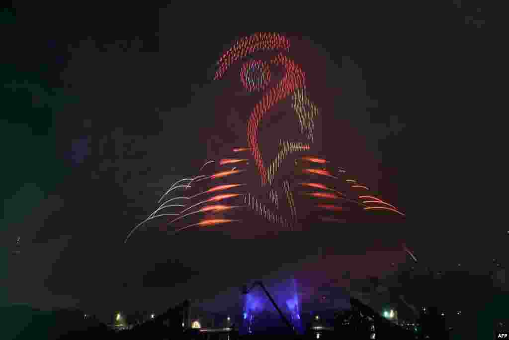 Lights illuminate the sky and shape the face of Marianne, the national personification of the French Republic, during a drone, lights and fireworks show in front of the Eiffel Tower as part of the annual Bastille Day celebrations and ahead of the Paris 2024 Olympic Games in Paris, France, July 14, 2024.&nbsp;