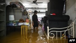 A man looks at his property before evacuating from a flooded area in Yong Peng, Malaysia's Johor state, on March 4, 2023.