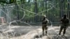 Polish troops guard the metal barrier border with Belarus, in Bialowieza Forest, May 29, 2024. Poland says neighboring Belarus and its main supporter Russia are behind a surging push by migrants in Belarus toward the European Union.