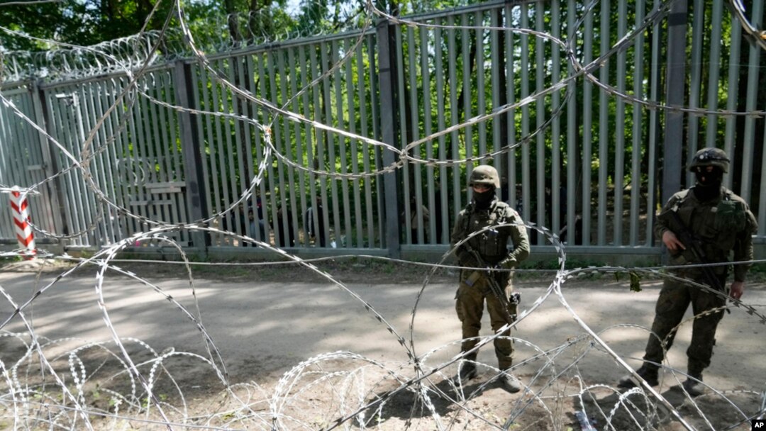 Polish troops guard the metal barrier border with Belarus, in Bialowieza Forest, May 29, 2024. Poland says neighboring Belarus and its main supporter Russia are behind a surging push by migrants in Belarus toward the European Union.