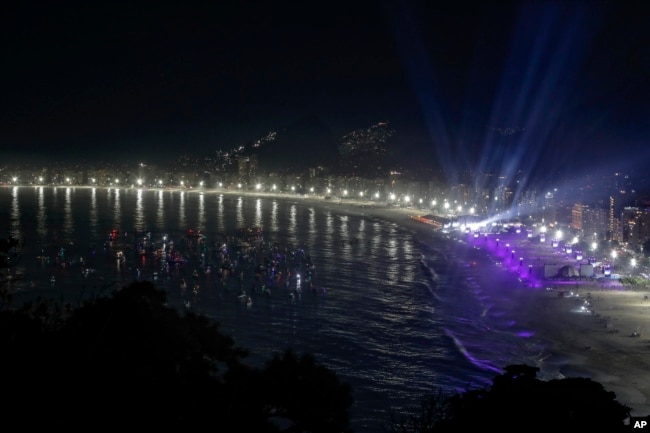 Boats sit idle off Copacabana beach as fans watch Madonna's final show of her The Celebration Tour in Rio de Janeiro, Brazil, on Saturday, May 4, 2024 (AP Photo/Bruna Prado)