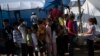 Children wait in line for a food distribution in a tent camp for the displaced, in Khan Younis, southern Gaza Strip, Oct. 25, 2023.