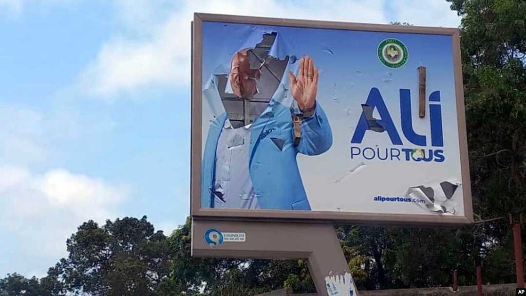 FILE - A defaced billboard of Gabon's ousted president, Ali Bongo, is seen on a street in Libreville, Gabon, Aug. 30, 2023. 