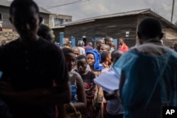 People wait to cast their votes at a polling station in Goma, eastern Democratic Republic of the Congo, Dec. 21, 2023.