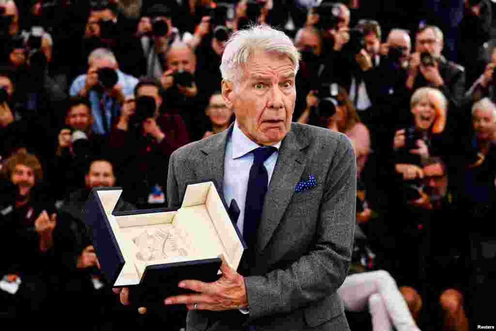 Actor Harrison Ford holds his Honorary Palme d'Or Award at the 76th Cannes Film Festival in Cannes, France.