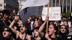 University students chant slogans during a protest as they head to the headquarters of private operator Hellenic Train, in Athens, March 3, 2023. 