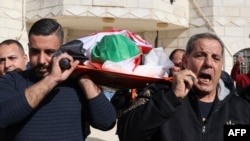 FILE - Palestinian relatives mourn during the funeral of Omar Assad, 78, who was found dead after being detained and handcuffed during an Israeli raid, in Jiljilya village in the Israeli-occupied West Bank, on Jan. 13, 2022.