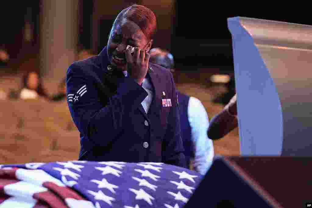 U.S. Air Force personnel stand near the coffin of slain airman Roger Fortson during his funeral at New Birth Missionary Baptist Church, near Atlanta, Georgia.