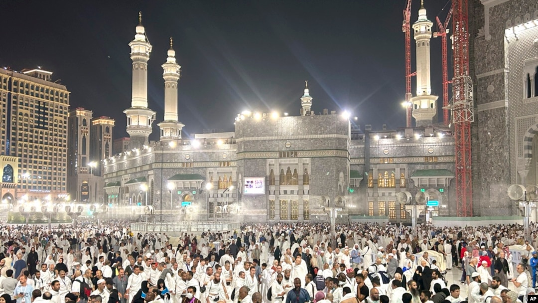 Pilgrims leave after offering prayers outside at the Grand Mosque during the annual Hajj pilgrimage in Mecca, Saudi Arabia, June 14, 2024.
