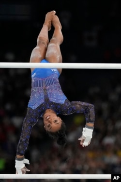 Simone Biles of the United States performs on the uneven bars during the women's artistic gymnastics all-around finals in Bercy Arena at the 2024 Summer Olympics in Paris, Aug. 1, 2024.