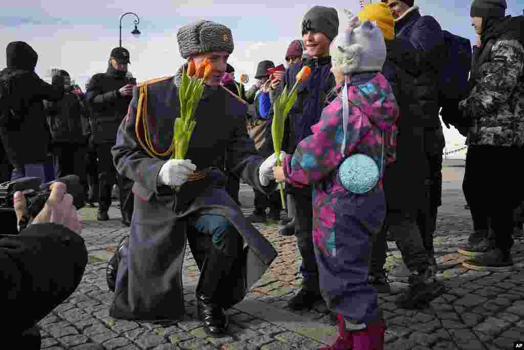 A honor guard soldier gives a flower to a girl on International Women&#39;s Day in St. Petersburg, Russia.&nbsp;International Women&#39;s Day on March 8 is an official holiday in Russia. Per tradition, men give flowers and gifts to female relatives, friends and colleagues.