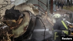 FILE - A firefighter extinguishes remains of an unidentified missile, which Ukrainian authorities claimed to have been made in North Korea, at a site of a Russian strike in Kharkiv, Ukraine, on Jan. 2, 2024.