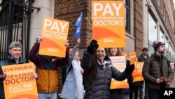 FILE - Junior doctors picket in London, March 14, 2023. Unions representing nurses, ambulance crews and other health care workers in England reached a deal March 16, 2023, to resolve strikes for higher wages, though the pact didn't include doctors.