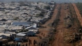 FILE-Internally displaced people gather by a water collection point in a United Nations Mission in South Sudan (UNMISS) Protection of Civilian site (PoC), outside the capital Juba, South 